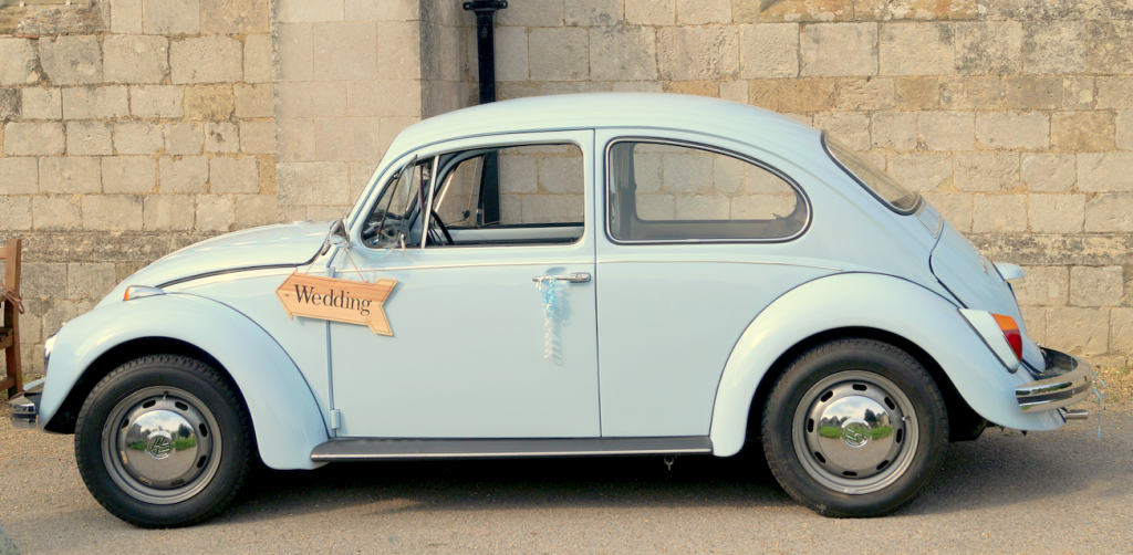 Bluebell with her Wedding sign outside St. Peter's Church, Bishops Waltham